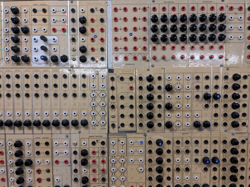 A panel of Serge synth modules with glossy hand applied paper labeling