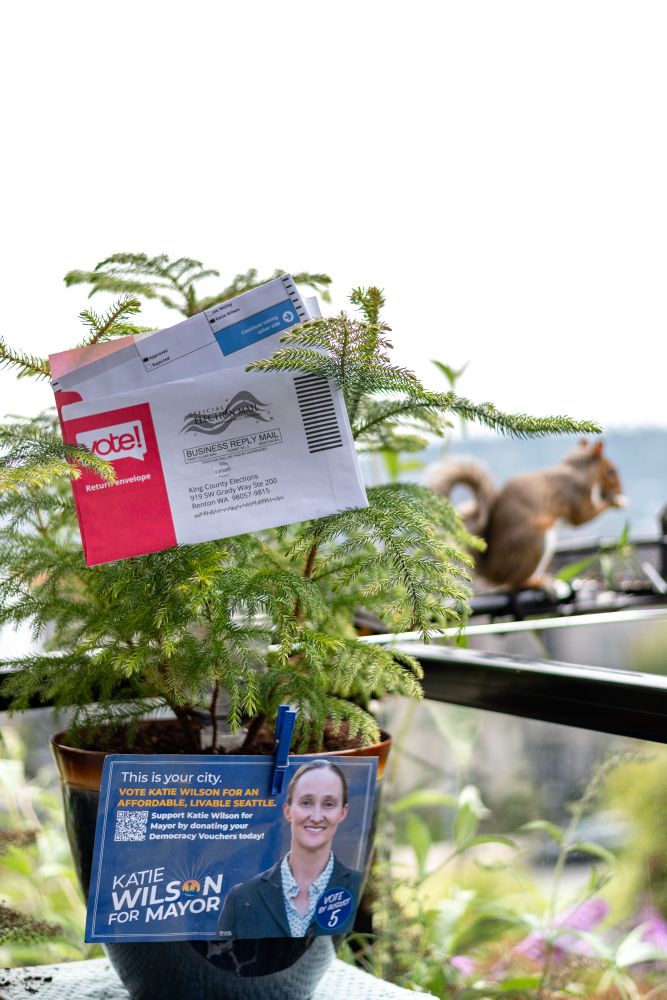 Ballot and Katie Lit with a squirrel stealing a snack.