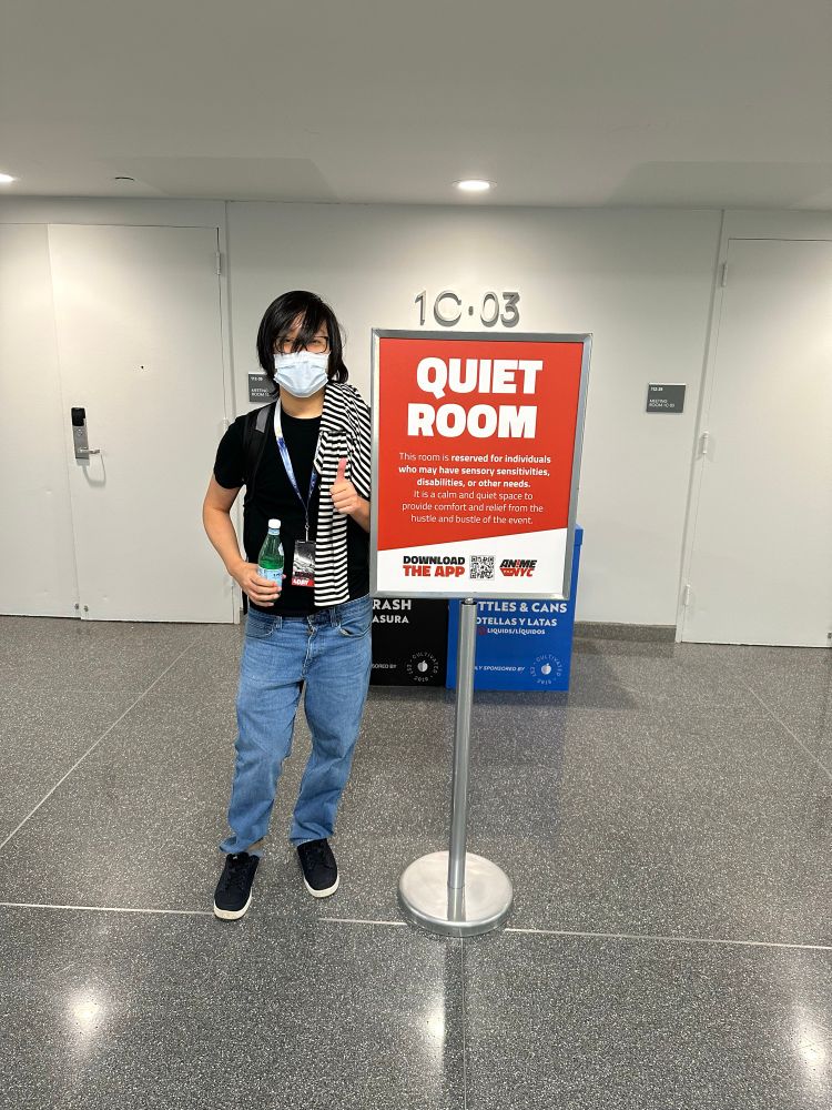 Me next to a sign that says Quiet Room, in front of some doors