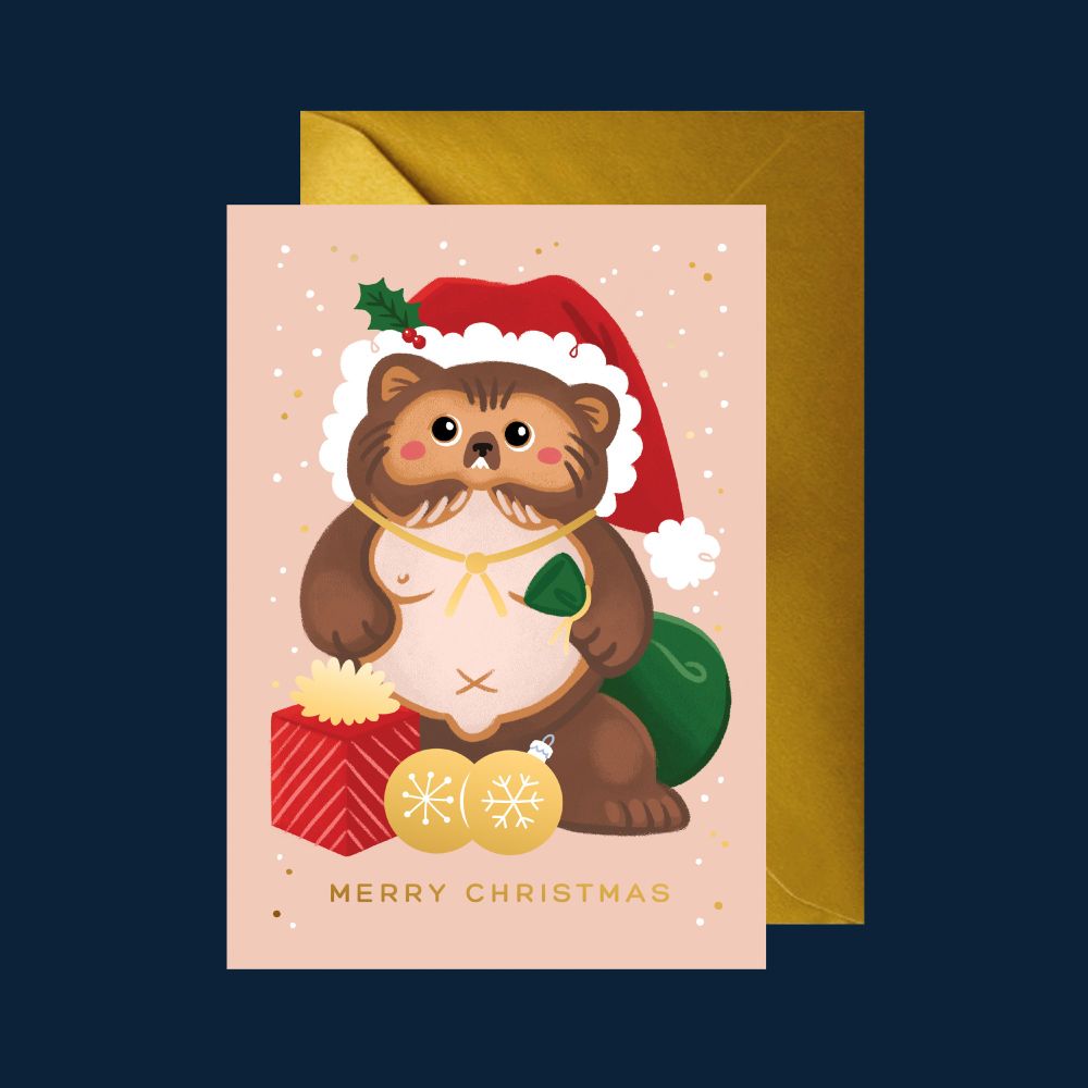 A Christmas card featuring a Japanese tanuki raccoon-dog wearing a Santa hat and holding a green sack. Two golden baubles sit at his feet.