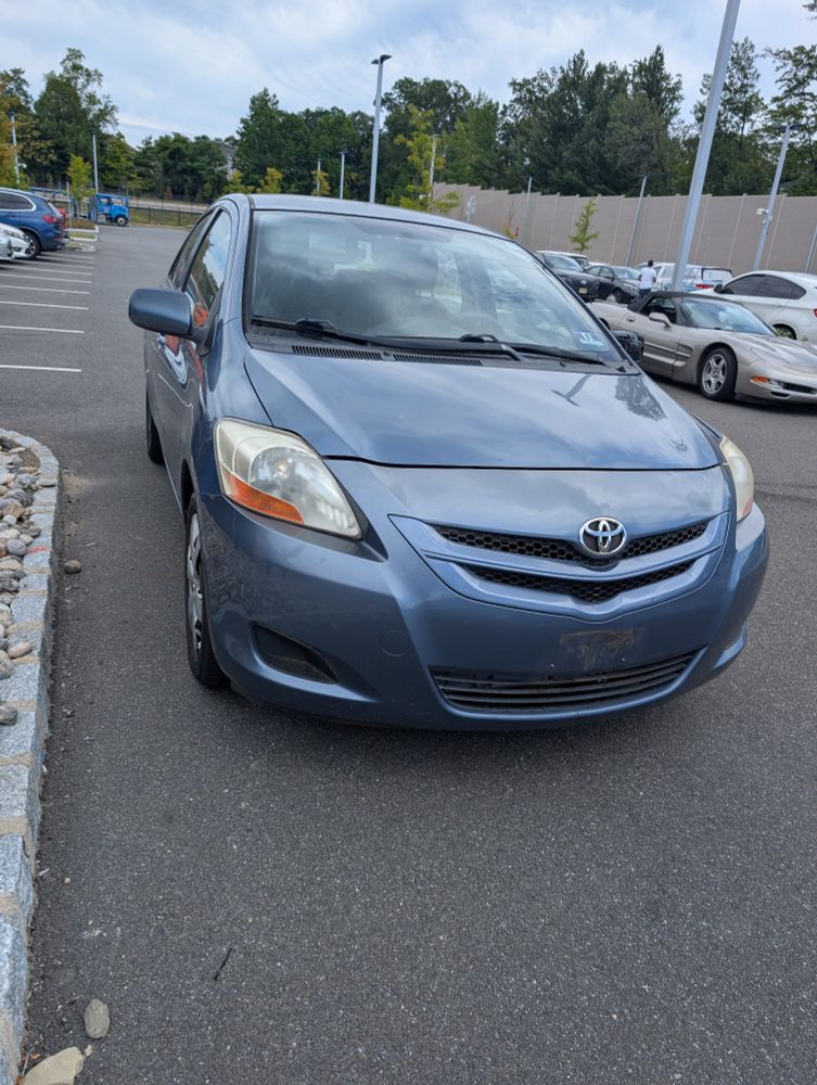 Blue Toyota Yaris in a parking lot