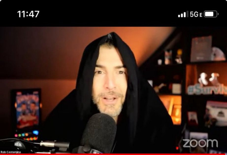 Rob wearing a hood while hosting RHAP version of the traitors