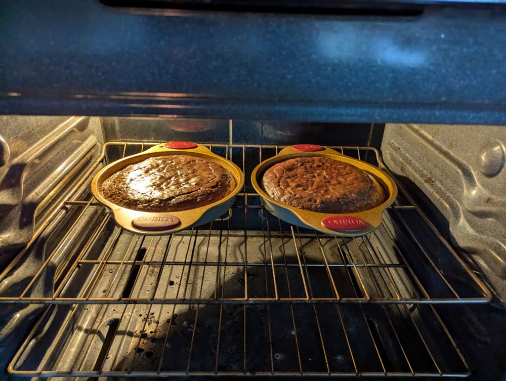 Two Chocolate cakes baking in an oven