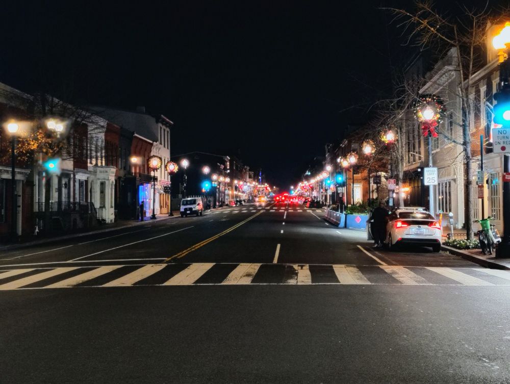M St in Georgetown St night under an empty sky with car lights and street lights 