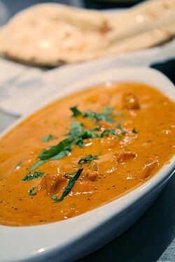 Chicken tikka masala, popularized across Britain by immigrant chefs during the 1960s.