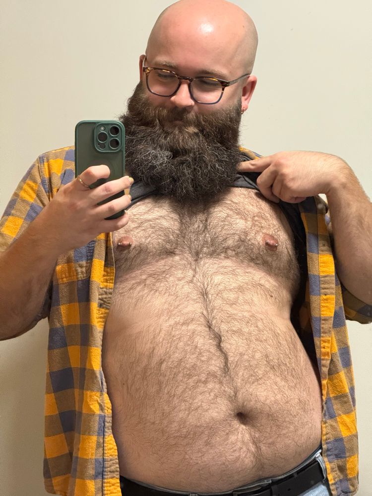 The author of this tweet lifting up their shirt to show you their hairy chest and belly.