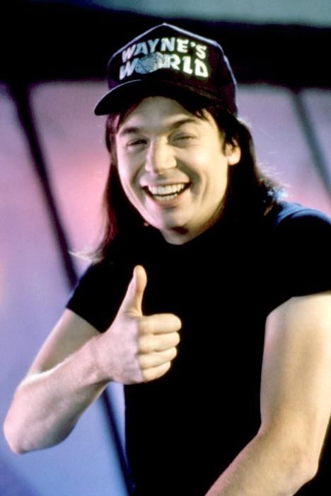 michael myers from the movie waynes world as glen campbell giving a prominent grin and thumbs up 
