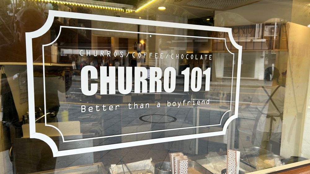 Company logo with byline on a churro shop in Seoul.