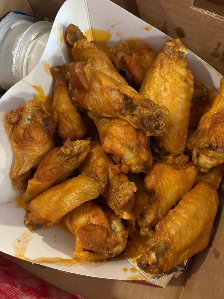 a box of a sparsely sauced double order of buffalo wings