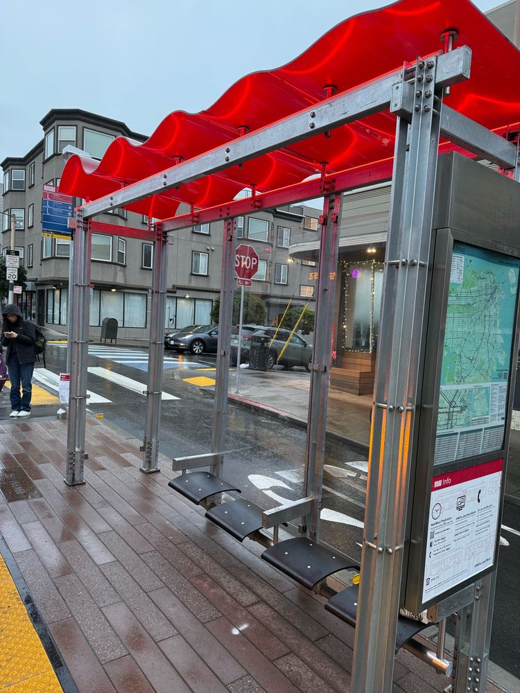 SF Muni rain shelter with comically small roof 