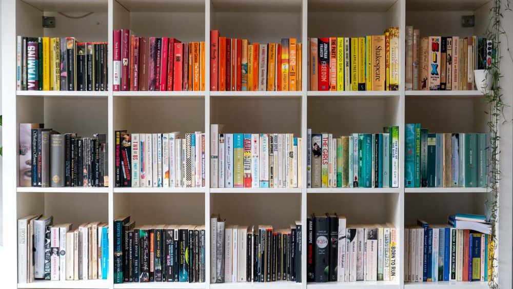 A bookshelf is displayed with books arranged by shades of color to create a pleasant-looking gradient effect. However, this also hurts usability