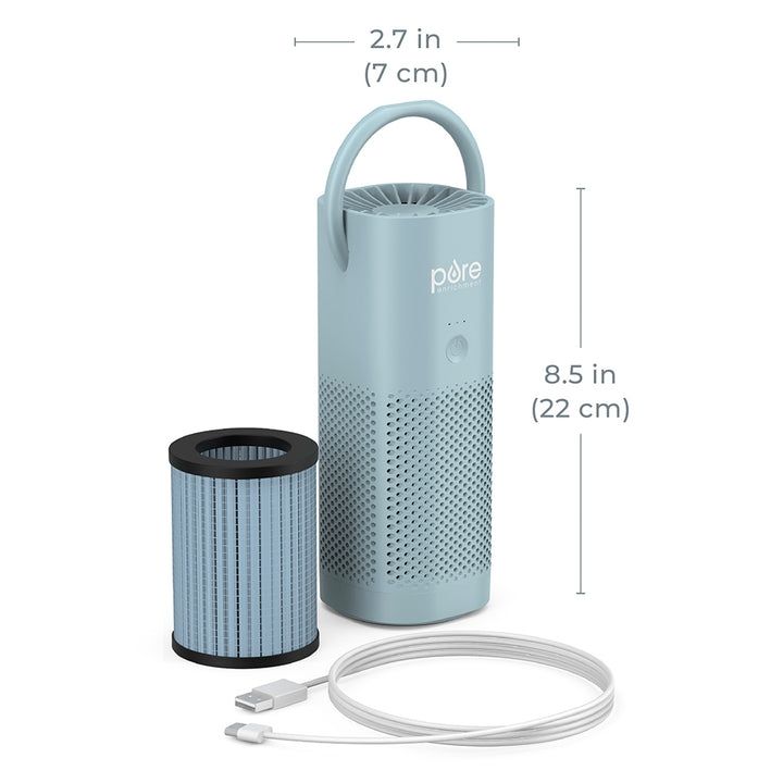 Photo of a Pure Enrichment hand-held air purifier, its filter, and its charging cord. The purifier is light grayish-blue with an almost perfectly cylindrical shape, and a small rounded handle at the top. The purifier measures 2.7 inches (7 cm) wide by 8.5 inches (22 cm) tall.