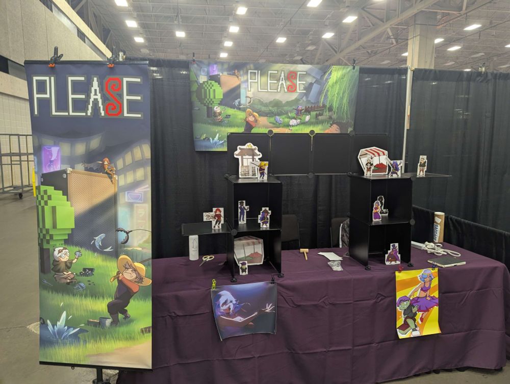 a booth with key art and banners that say "PLEASE" the game title. The S is stylized in red.