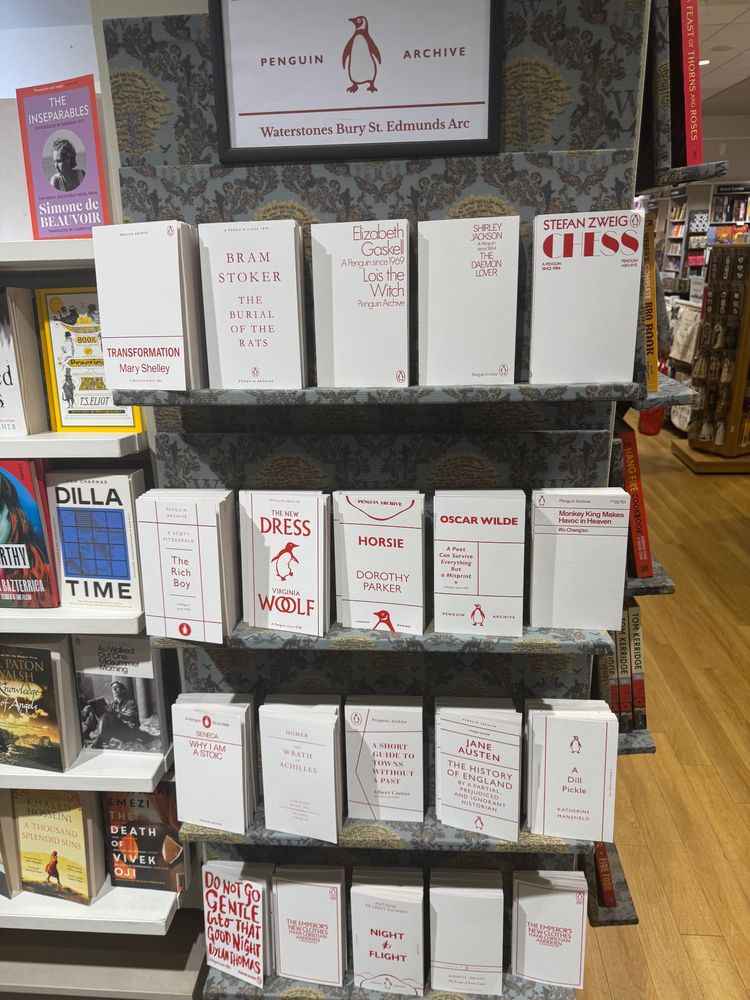 A bookshelf in Waterstones bookshop in the United Kingdom. The covers are white and the text is red to celebrate Penguins Archvie. 