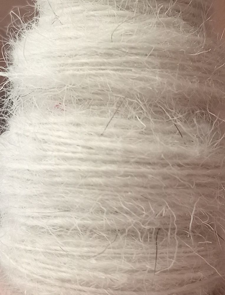 White wool spun into yarn with lots of hairy bits.