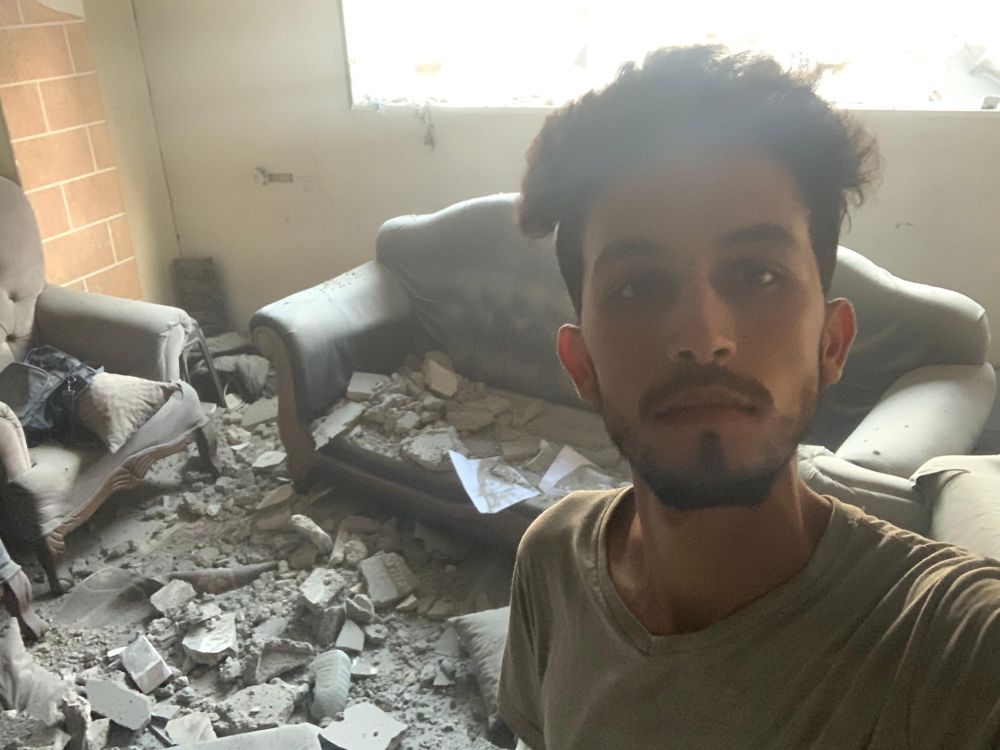 Mohammed Shobair, 22, from Gaza, in the ruins of his old flat