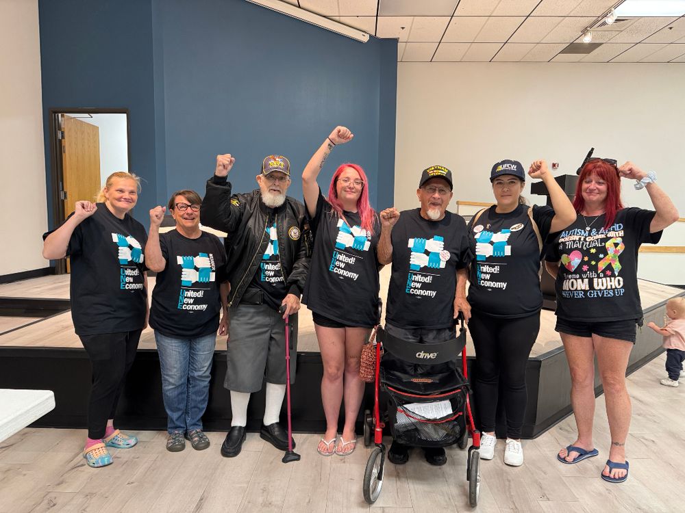 UNE members stand in their power after a successful public meeting.