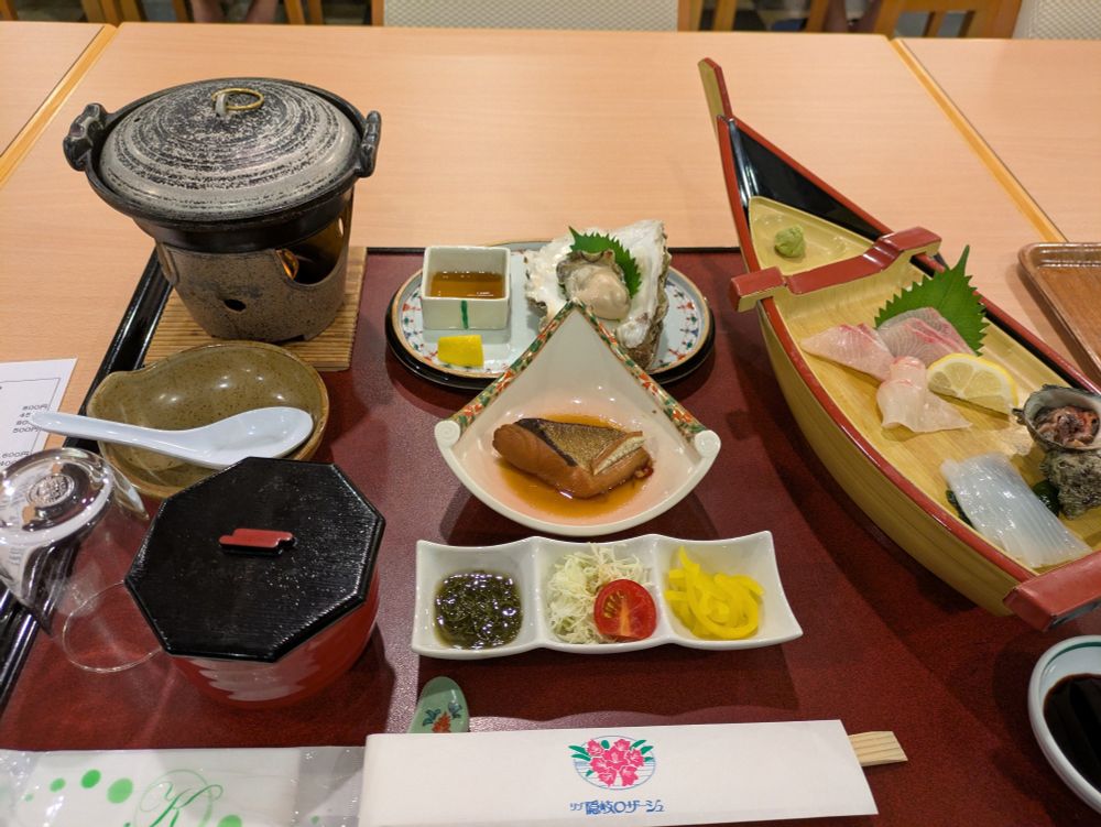Japanese cuisine meal set plate, composed of sliced raw fish, oyster, boiled fish, rice and so on