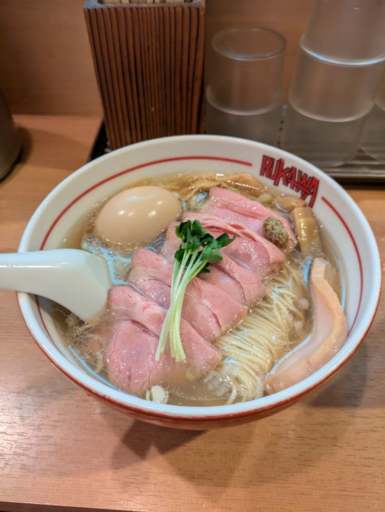 A photo of a ramen, with white soup and thin noodles