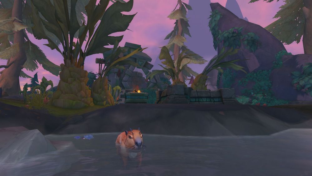 Warcraft screenshot of a dilapidated Amani shrine with hot springs and a capybara in the foreground, against a rosy pink sky.