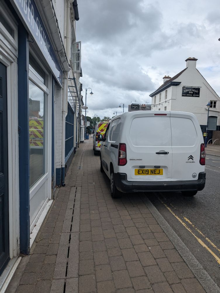 Two vans parked like utter bellends. On double yellow lines, because CUNTS. 