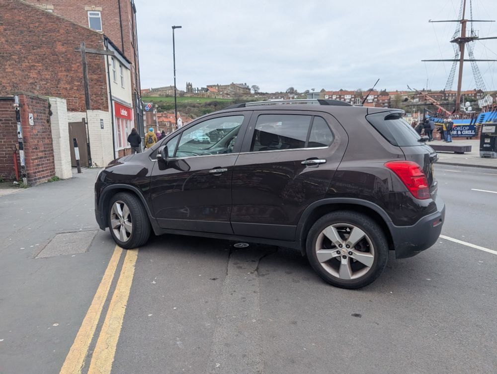 Not really sure how to describe this... It's a black car, one wheel and one wheel only, touching the double yellow lines... It's parked sort of nose in, sort of on the pavement. Kind of looks like the driver just twisted the wheel, closed their eyes and went for it. Cunt. 