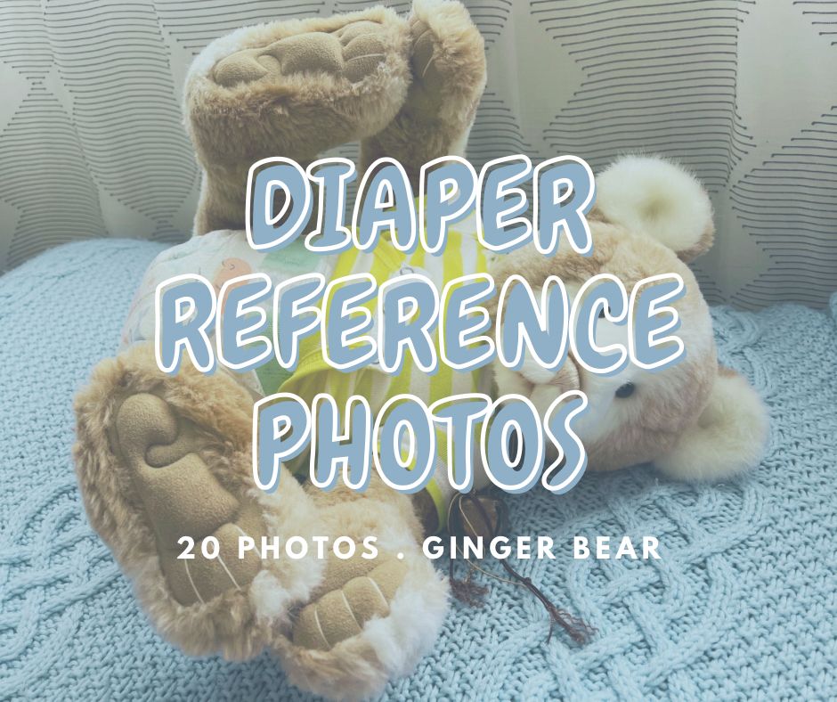 A stuffed bear on a blanket wearing a onesie and diaper