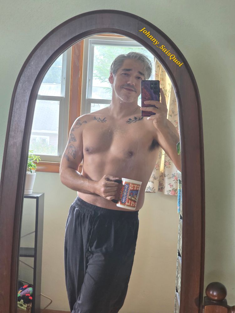 An older Korean man with salt and pepper hair is shirtless, holding a cup of coffee. His tattoos, chest, and armpits are visible.