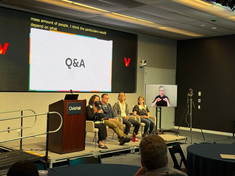 Four seated speakers answer questions 
