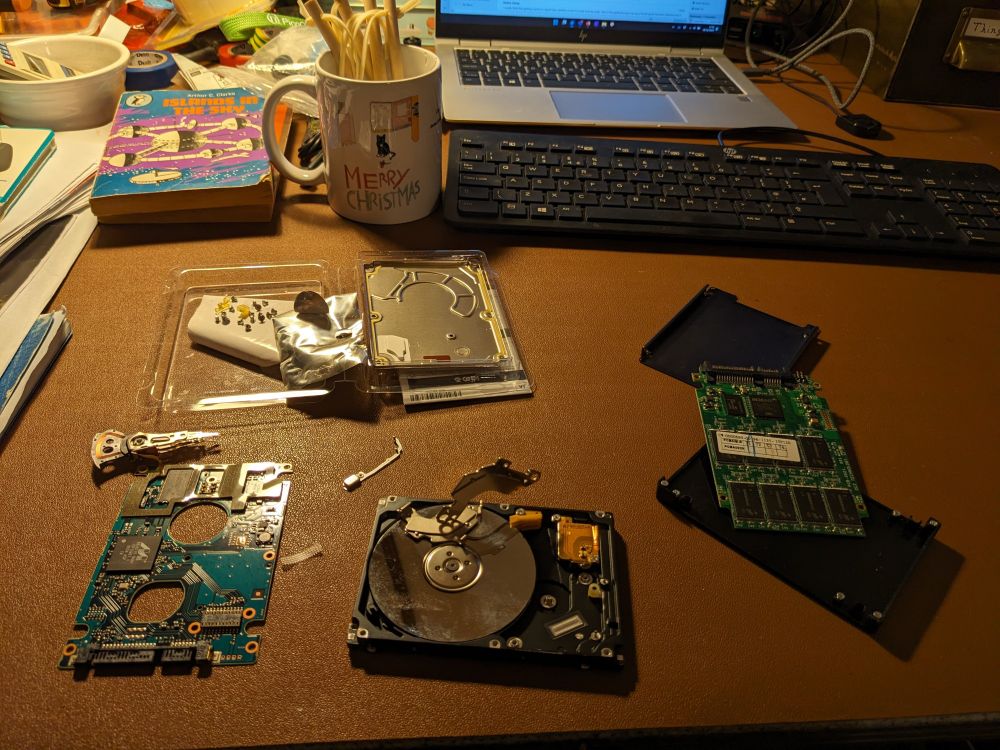 A magnetic hard drive, and an SSD hard drive, dismantled. 
Magnets on show.