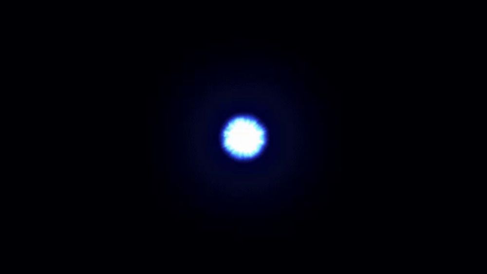 a blue and red glowing object in the dark