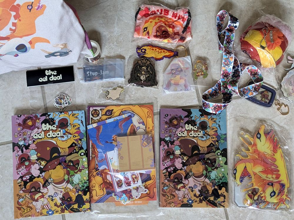 many fan made merch about frye from splatoon3. artbook, keychains, buttons, stickers, by the way Frye is associated with a yellow moray eel.