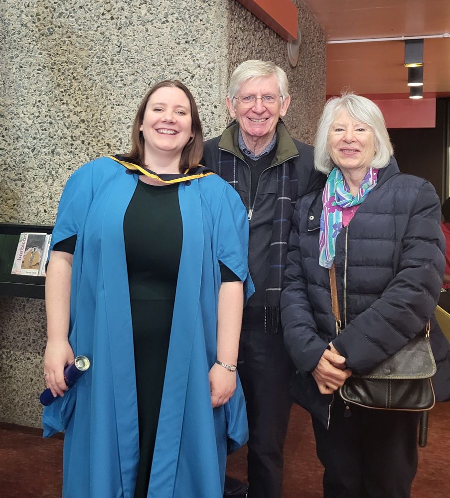 Graduate and their parents smiling