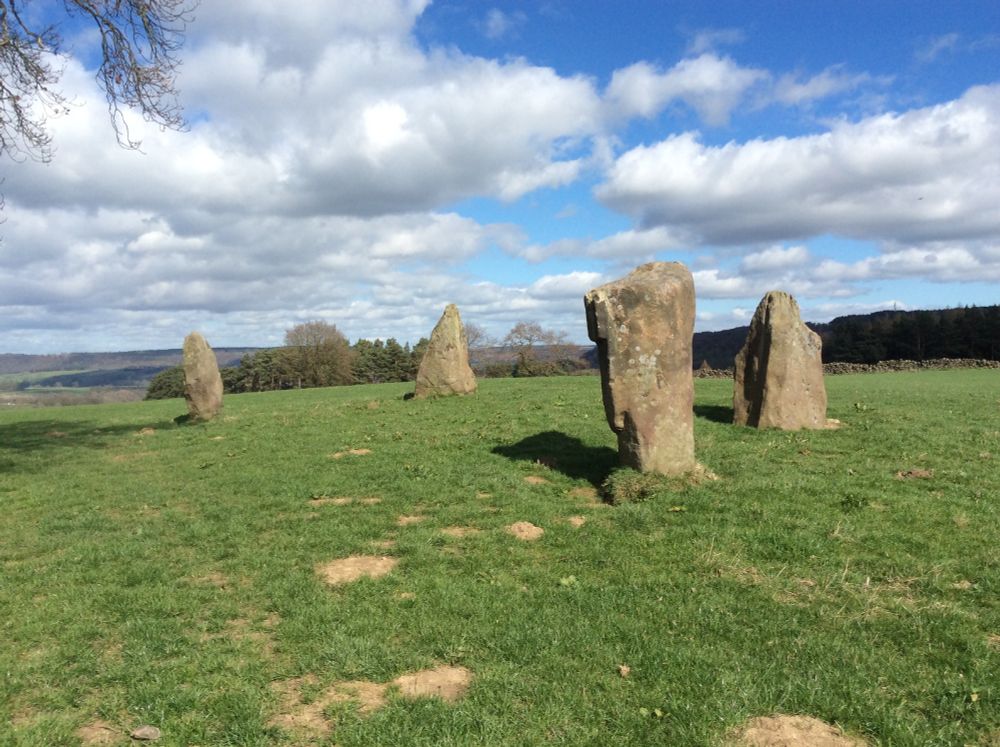 A colour image of four standing stones known as 9 Stone Close. Up to a little over 2 metres tall they are the largest standing stones in the Peak District and Derbyshire.