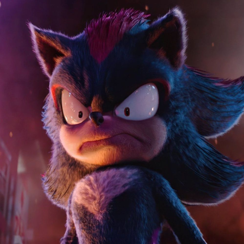 An altered image of Shadow the Hedgehog, as he appears in the movie "Sonic the Hedgehog 3", with a comically enlarged grimace and comically shrunken pupils