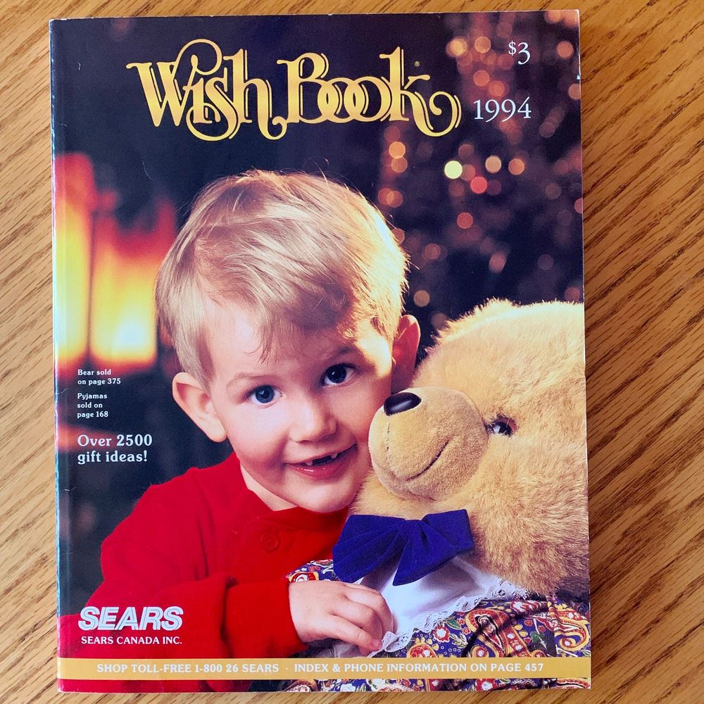 Sears Wish Book catalogue from 1994, price $3. Cover has young, blond boy, with smile, holding a large, light brown teddy bear. Blurry Christmas tree and fireplace in background