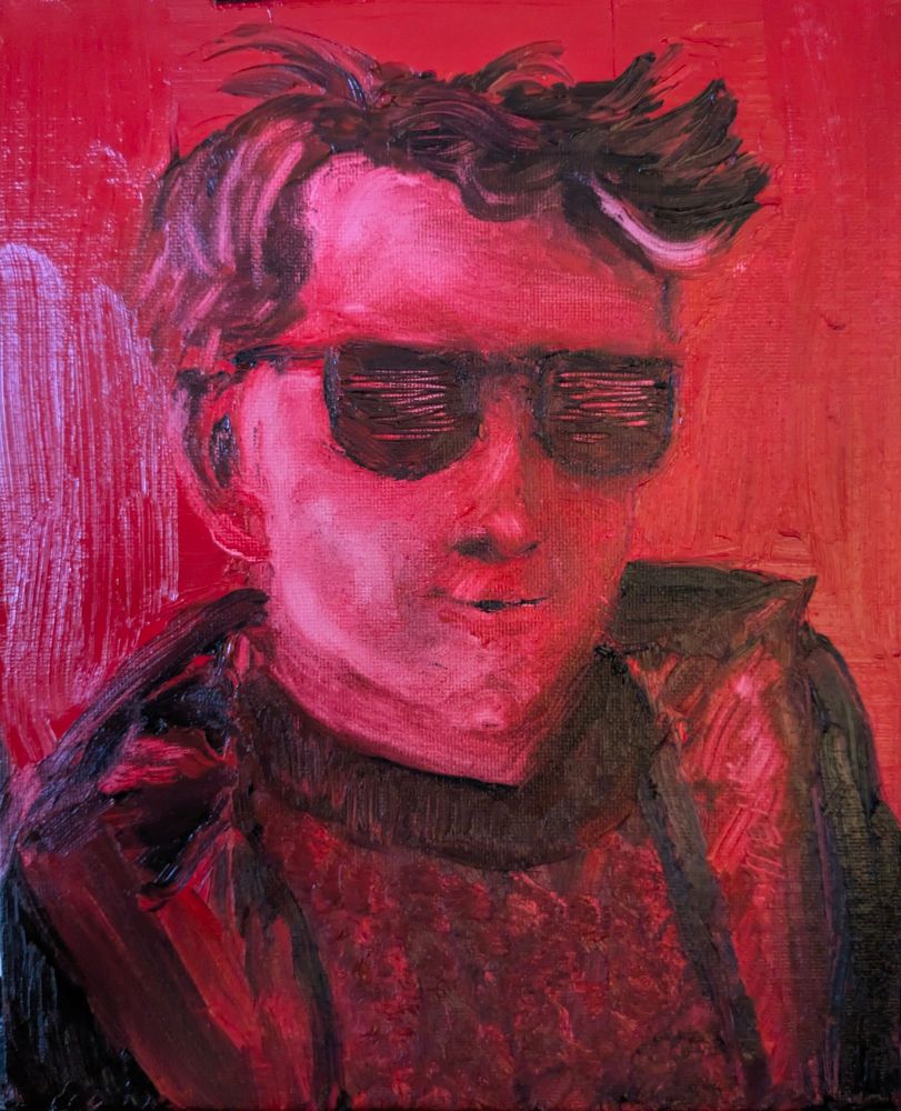 An oil painting portrait of a person with short, tousled hair wearing large, dark sunglasses and a dark jacket over a high-collared shirt. 

The entire painting is executed in shades of red, with the background, face, and clothing all blending together through expressive, textured brushstrokes. 

The sunglasses and hair are rendered in deeper, almost blackish reds, while the face is lighter but still predominantly red. The figure’s features are suggested more than precisely defined, giving the painting a bold, stylized, and somewhat abstract quality. 

The brushwork is loose and energetic, especially in the hair and clothing, while the background is a flat, solid red.