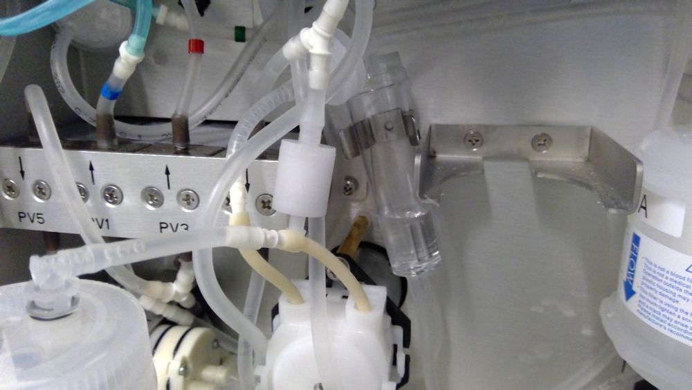 Tubing, pumps, a sheath damper and the sheath filter inside the right side of a CytoFLEX instrument. Right panel removed.