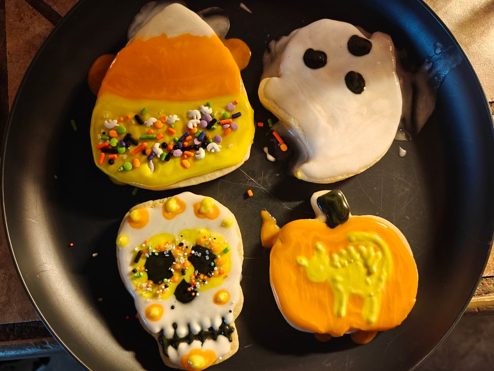 Decorated sugar cookies. I made a candy corn, ghost, sugar skull and pumpkin with a hissing cat design