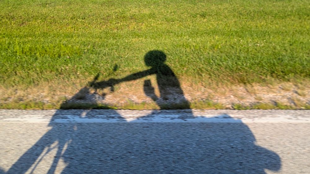 the evening shadow cast by a motorcycle 