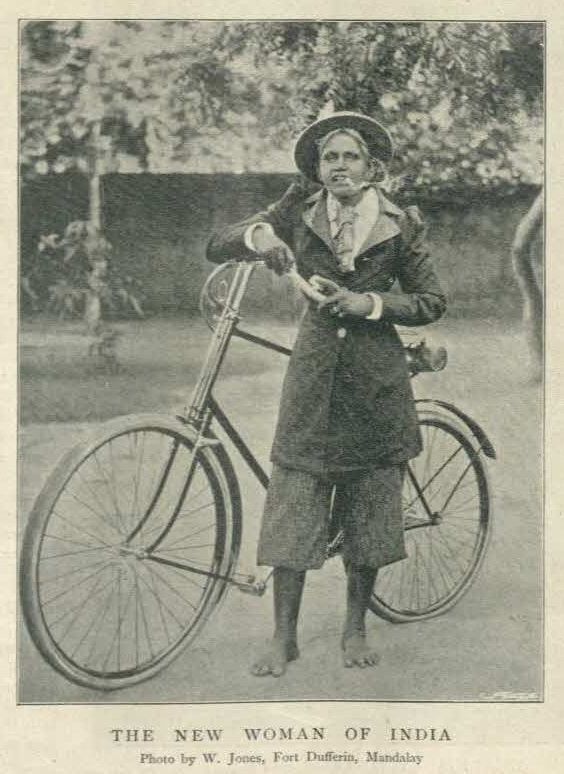 An older woman in British-occupied India, wearing a bicycle suit from the 1910s or 1920s. She's serving and she knows it.