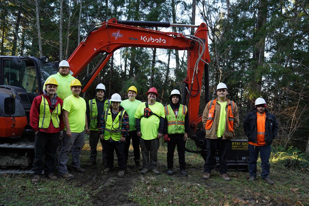 Trainees pose at a work site in front of a loader. The trainees are 
(left-top) Kevin Downs, Zechariah Gable, Poy-wuson Aguilar, Darren Ray, Makeala Jordan, Richard Nelson IV, Steven Nova, Kyle Downs, Jackson Bowen and Bear Romannose-Jones.
