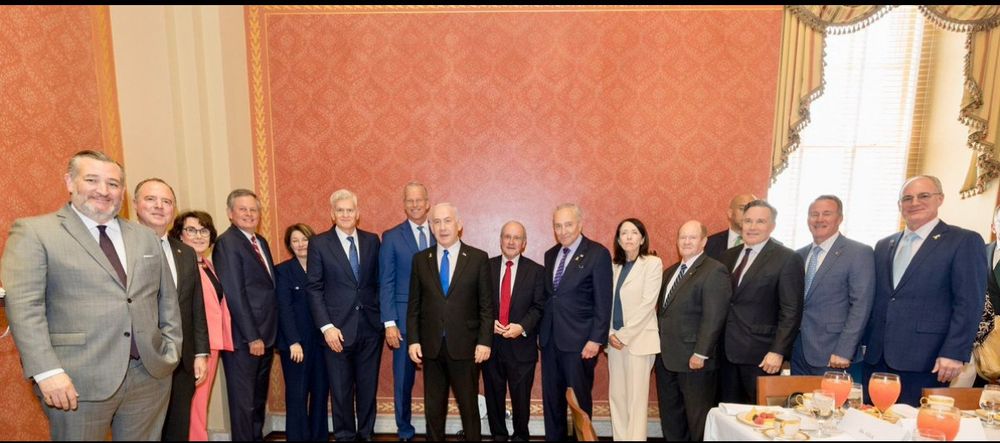 A bunch of US senators posing with the genocidal PM of Israel Netanyahu