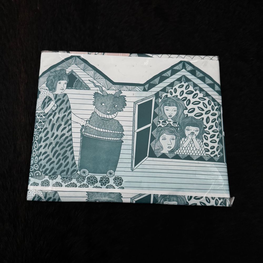 Calendar wrapped in blue and white paper featuring the art of Erika Rier 