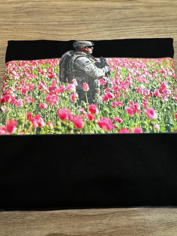 a USA soldier is guarding a field of opium poppies in Afghanistan