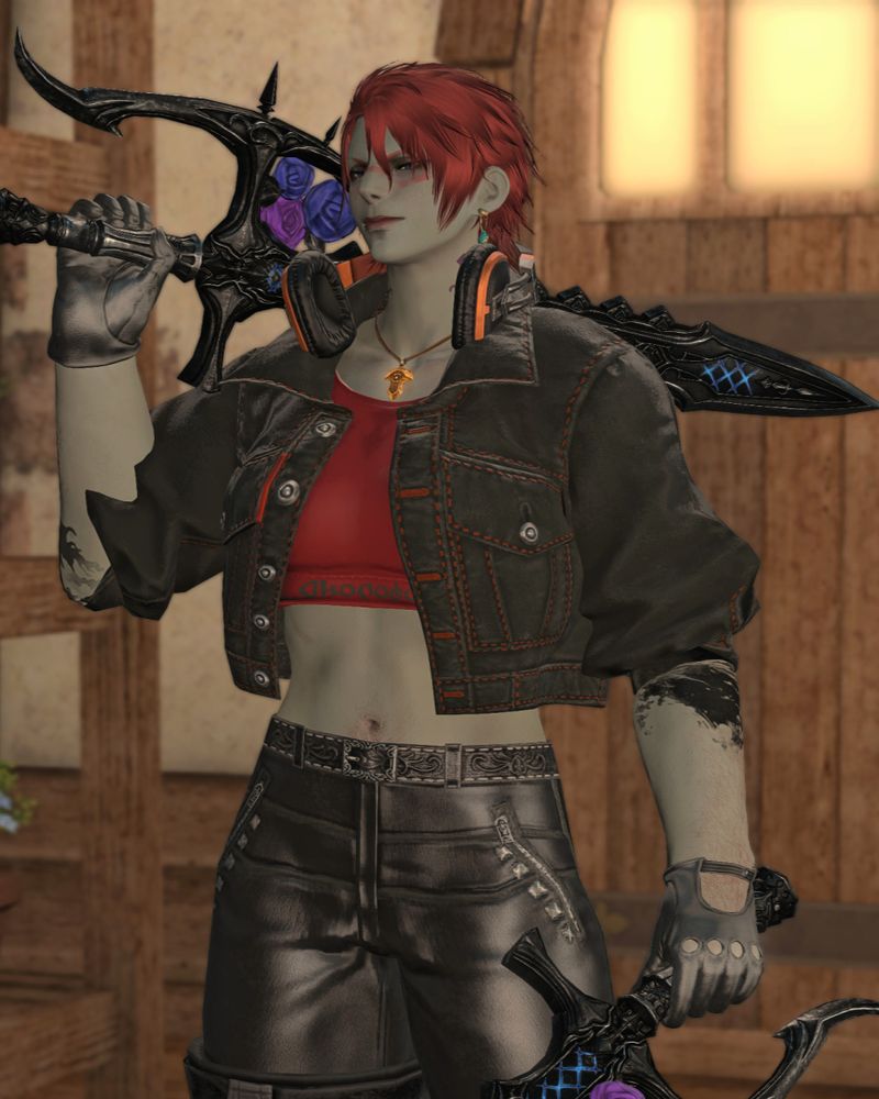 A vertical shot of a female Sea Wolf Roegadyn from the thighs up, named Elilgeim Wiltarwyn, or Ellie for short. She has green skin, red hair, blue eyes, and is tall and muscular. She wears a black denim jacket with a red crop top underneath, and leather gloves and pants. A pair of headphones are around her neck as well as the Azem crystal on a necklace. She carries one viper blade in each hand, the Edenmorn Twinfangs. She's looking out of the side of her eye at the viewer with a confident smirk.