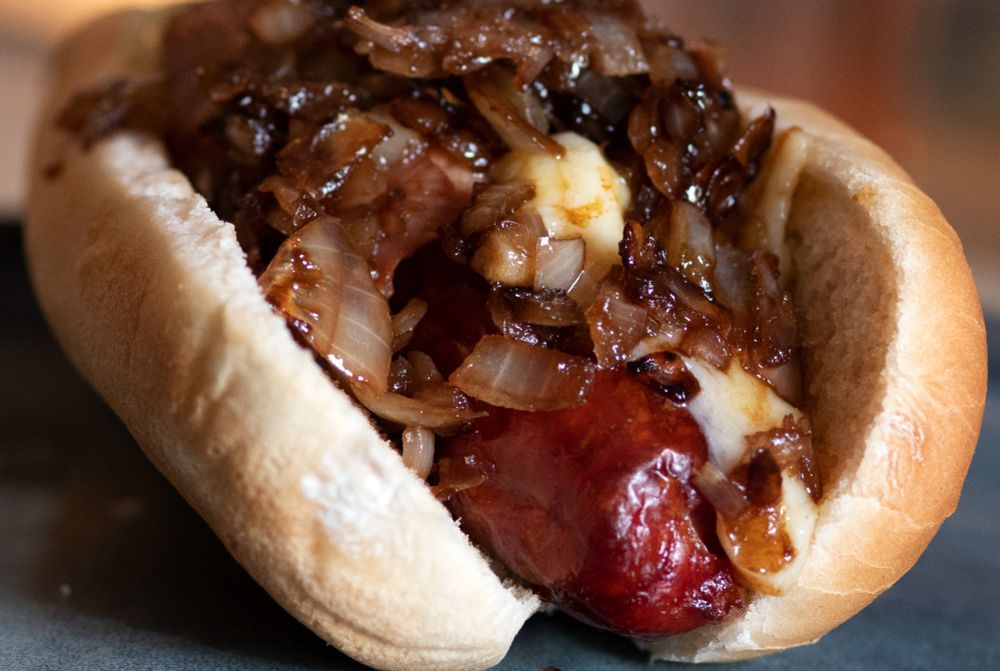 Hot dog with caramelised onions and cheese