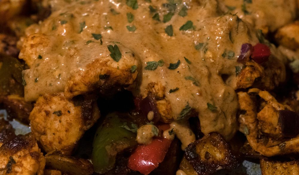 Seasoned diced chicken, potatoes, peppers and onion covered in a creamy herby sauce