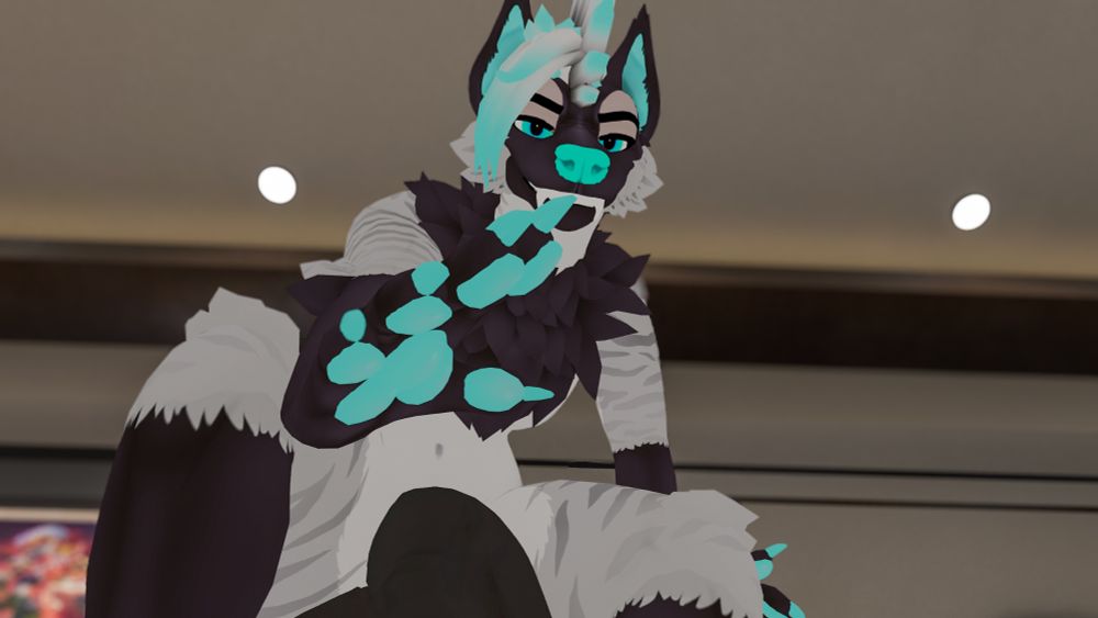 Big yeen reaching down to grab a tiny toy.