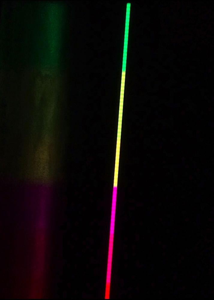 a pole of led lights go from green to pink to red, with a sharp transition between the green and pink.